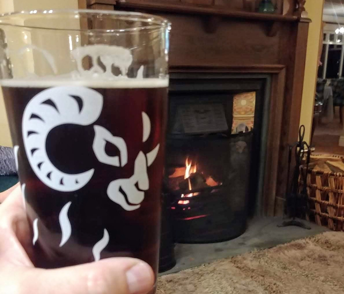 Real ale in front of a pub fire. Image by Media Helping Media released via Creative Commons BY-NC-SA 4.0